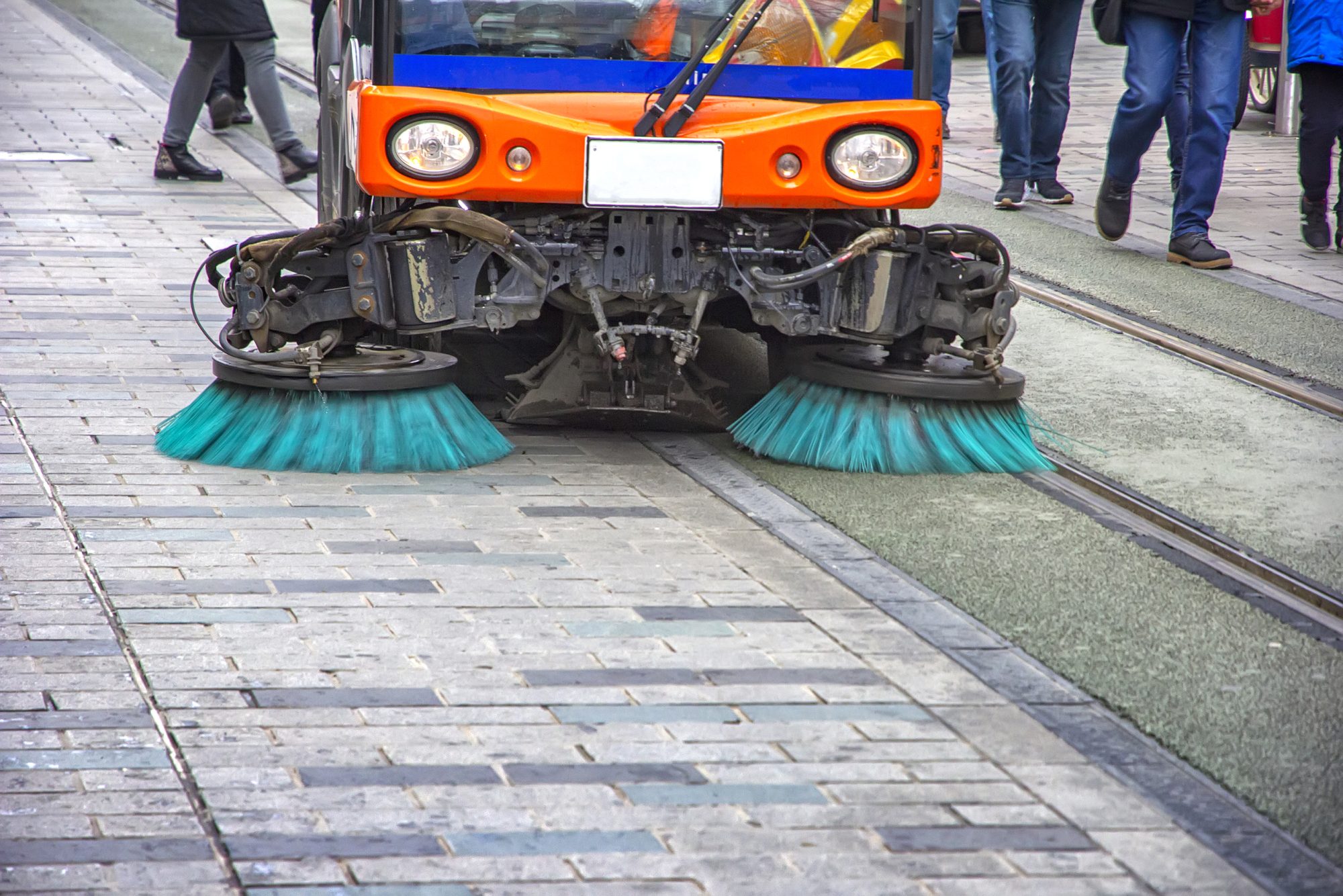 Modern street management with orange street sweeper truck